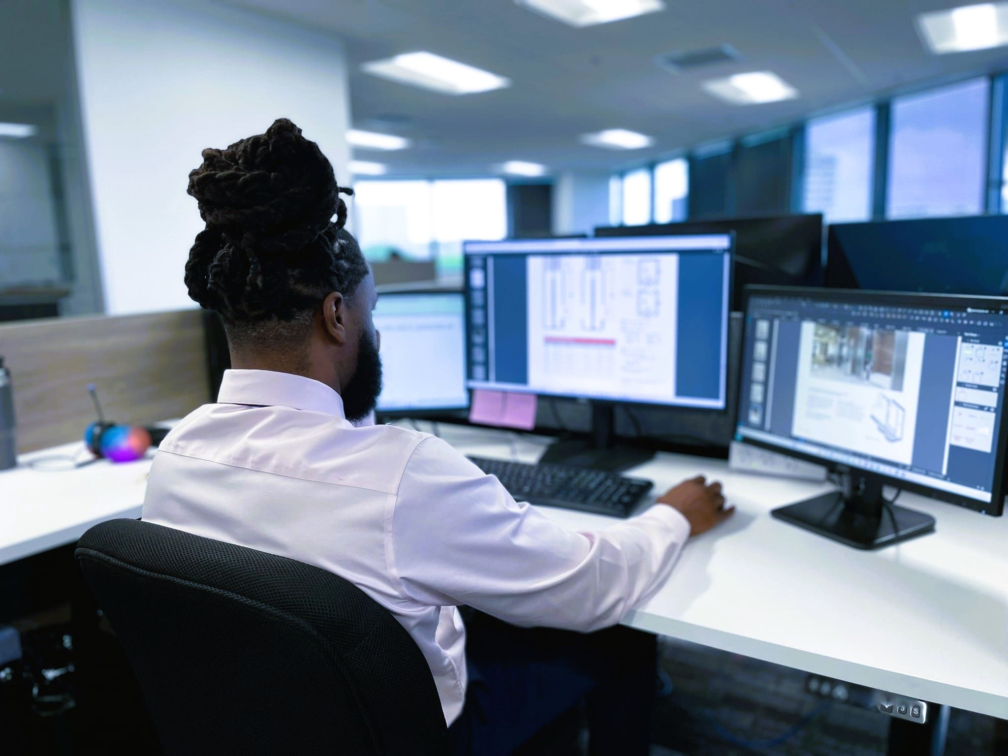 Engineer working on computer at a desk in an office.